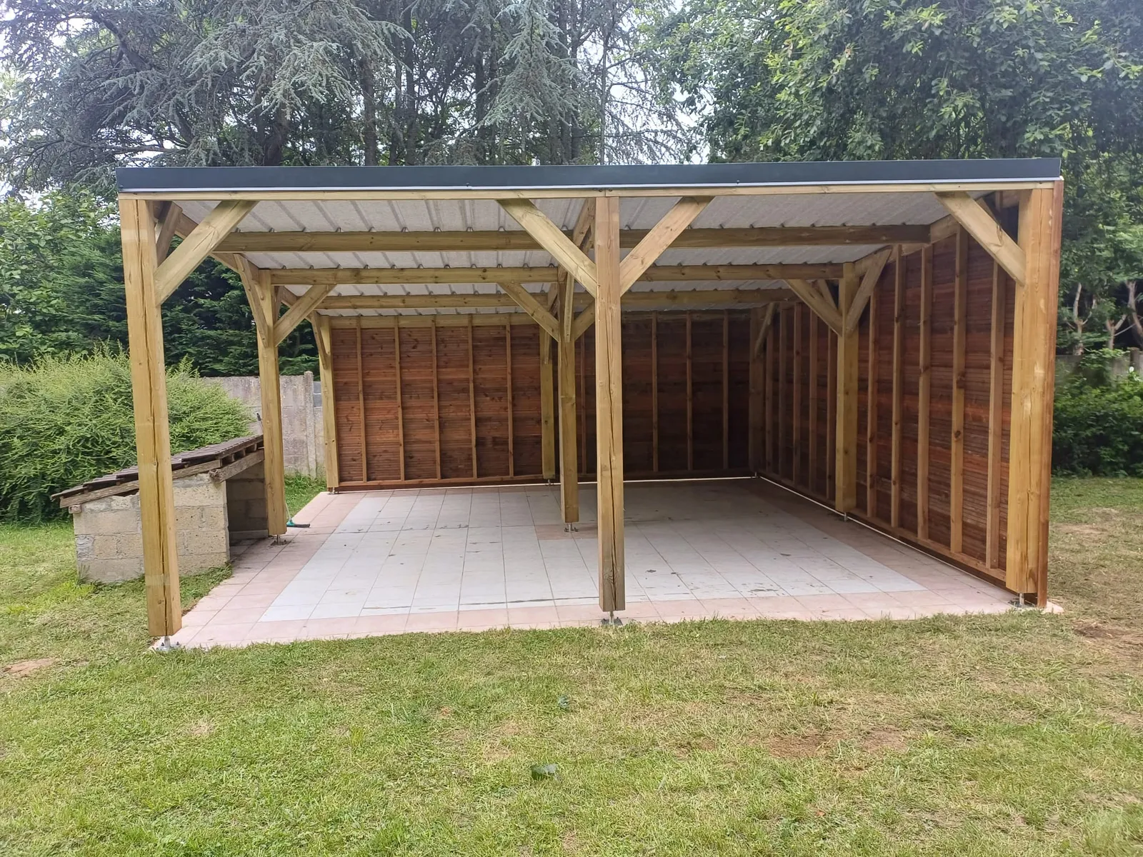 Carport bois bardé sur un côté, vue de trois-quarts, réalisé dans l'Aisne