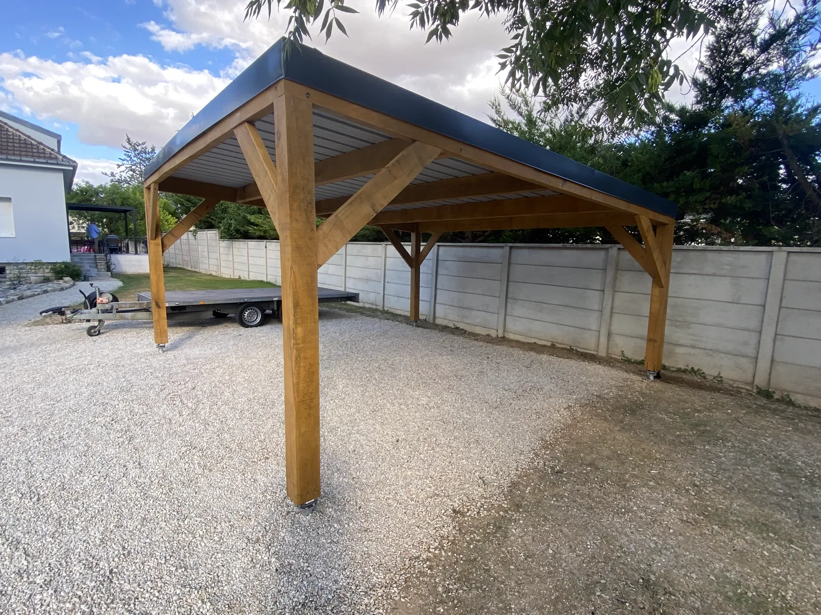 Carport en chêne massif terminé, vue du pignon avec toiture bac acier anthracite deux pentes, Pont-Sainte-Marie près de Troyes