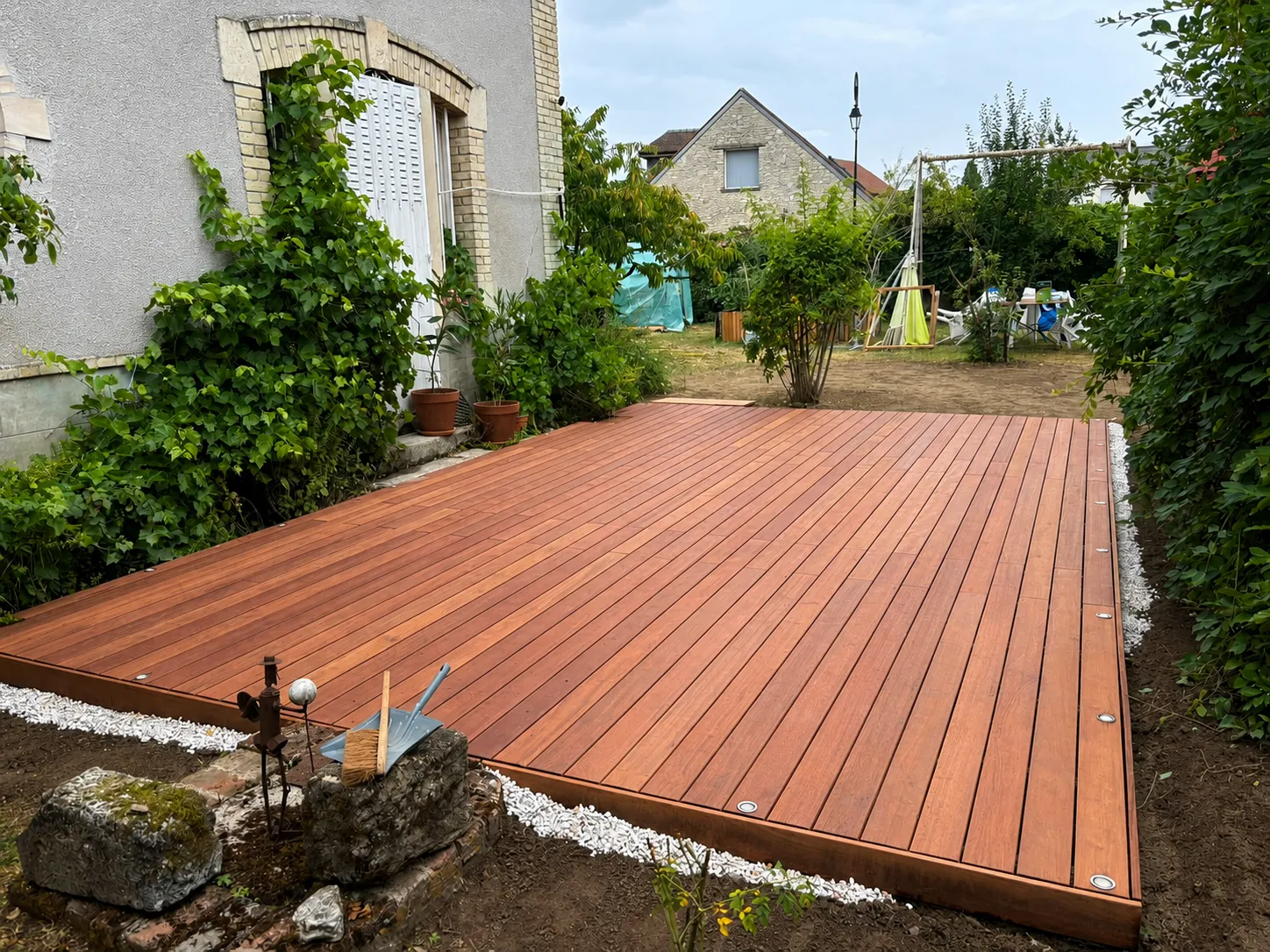 Terrasse en bois exotique de 30 m² avec spots LED encastrés, posée le long d'une maison ancienne à Hermonville, près de Reims